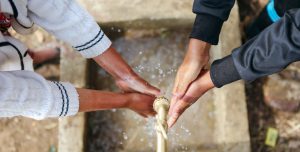 washing hands together | Water For People Jobs | Careers | Water For People